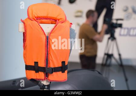 Dresden, Germany. 14th June, 2016. The mock-up of a life vest hangs in the exhibition 'Migration. Emigration - Flight - Displacement' in the Dresden Transport Museum in Dresden; Germany, 14 June 2016. The exhibition from 16 June to 30 December 2016 draws attention to this aspect: the history of migration is also the history of transport. Photo: SEBASTIAN KAHNERT/dpa © dpa picture alliance/Alamy Live News