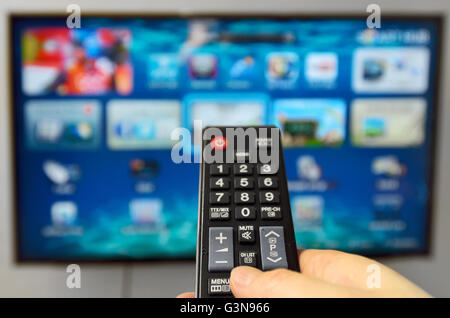 Smart tv and hand hold the remote control Stock Photo