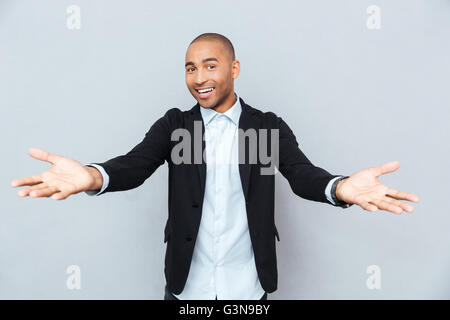 Modern young handsome happy african man smiling on isolated gray background Stock Photo