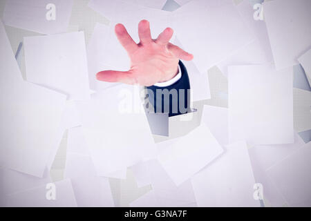 Composite image of mid section of a businessman with hands on a table Stock Photo