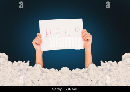 Composite image of woman holding help written on paper Stock Photo