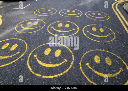 Smiley faces painted on a road Stock Photo