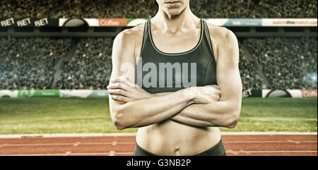 Composite image of athlete posing with arms crossed Stock Photo