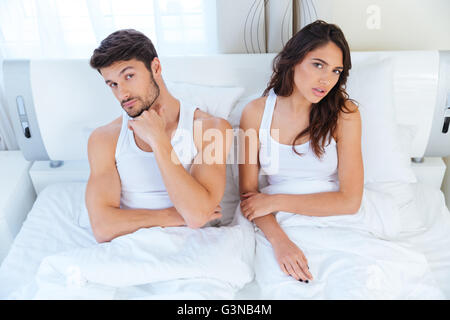 Unhappy couple not talking after an argument in bed at home Stock Photo