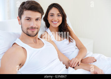 Beautiful young couple relaxing in bed at home Stock Photo