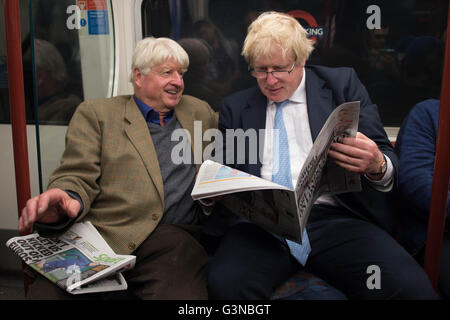 Boris Johnson sits next to his father Stanley (left) on the Bakerloo Line as he bumped into him by chance on the tube train as it left Marylebone Station in London. Stock Photo