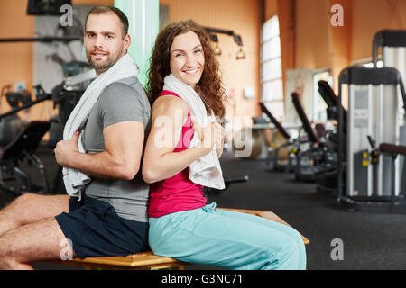 Man and woman taking a break during workout at the gym Stock Photo