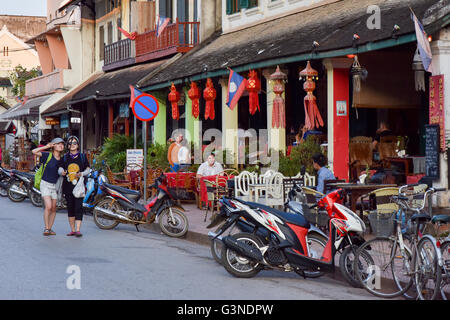Luang Prabang Laos, Tourists taking selfies on main commercial street Stock Photo