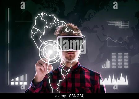 Man wearing virtual reality goggles. Studio shot, black backgrou Stock Photo