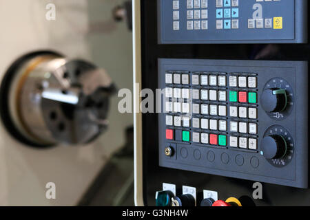 Close up of horizontal cnc turn mill machine with open door. Selective focus on control panel. Stock Photo