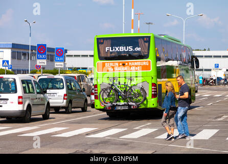 BERLIN / GERMANY - JUNE 4, 2016: german mercedes benz bus from flixbus arrives the airport in schoenefeld, berlin / germany at j Stock Photo