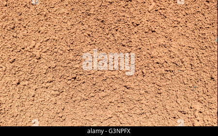 Painted textured surface of a wall covered with terracotta stucco background texture Stock Photo