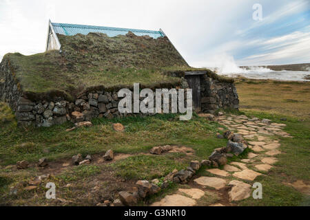 Sod roofed building with large rocks for a wall on a grassy plain on the geyser field, Hveravellir, Kjolur Route on the Interior Stock Photo