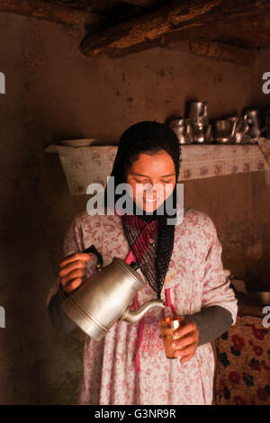 Berber teenaged girl pouring mint tea; Ait Souka Village, High Atlas Mountains, Morocco Stock Photo