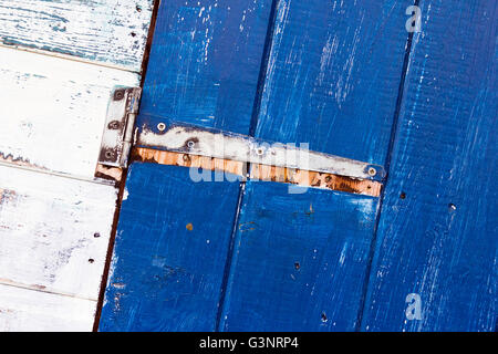 Rustic blue door with rusty hinge Stock Photo