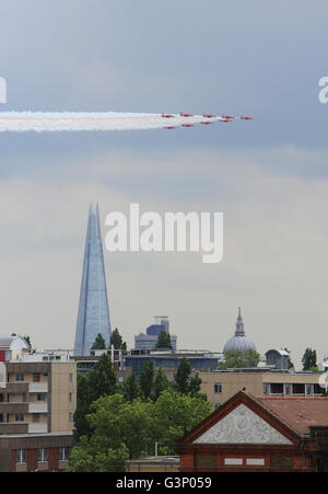 The Red Arrows fly past the London Shard, towards Buckingham Palace and the Mall, for the Queen's official birthday celebrations Stock Photo