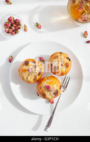 Muffin, mini cake, cup cake with a rose buds tea Stock Photo