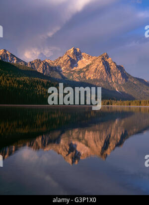 USA, Idaho, Sawtooth National Recreation Area, Morning storm clouds over McGown Peak which is reflected in Stanley Lake. Stock Photo