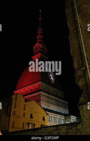 On 4 may, the 67 anniversary of the Superga air disaster, where players of the 'Grande Torino' lost their lives in a plane crash, the symbol of Turin, the Mole Antonelliana is lighted with red-Garnet and the main façade is projected the team's symbol (Photo by: Daniela Parra Saiani/Pacific Press) Stock Photo