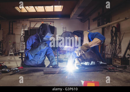Welder colleague working on a piece of steel Stock Photo