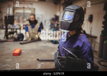 Female welder in protective workwear Stock Photo