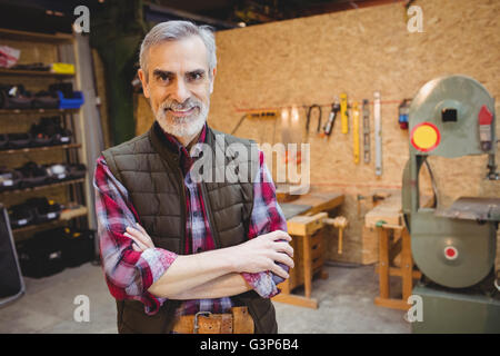 Carpenter with arms crossed is looking at camera Stock Photo