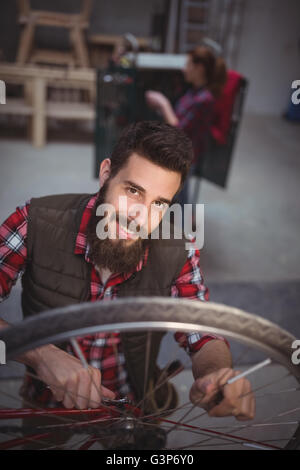 Portrait of mechanic repairing a bicycle Stock Photo