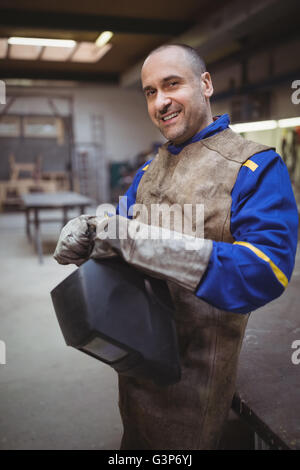 Side view of welder smiling and posing Stock Photo