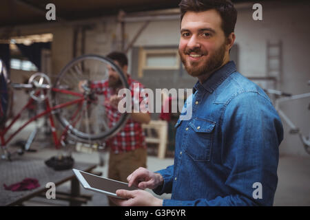 Man mechanic smiling and using a tablet computer Stock Photo
