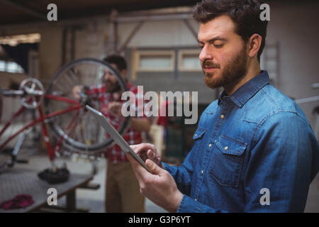 Side view of man mechanic using a tablet computer Stock Photo