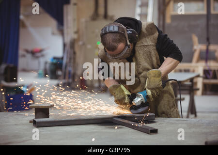 Worker using an angle grinder Stock Photo