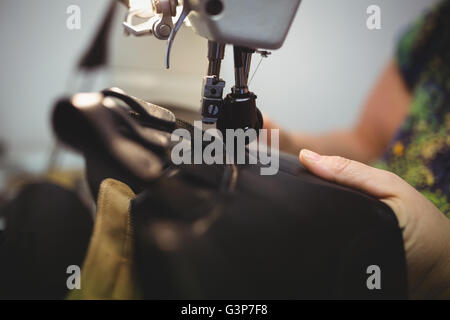 Close-up view of a cobbler using a sewing Stock Photo