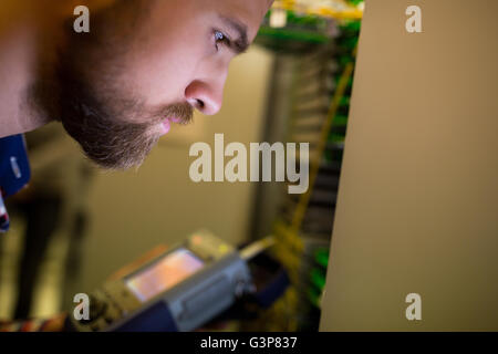 Technician using digital cable analyzer Stock Photo