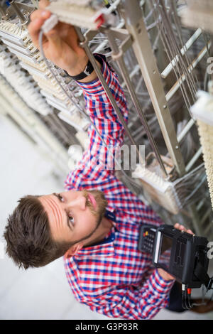 Technician using digital cable analyzer Stock Photo