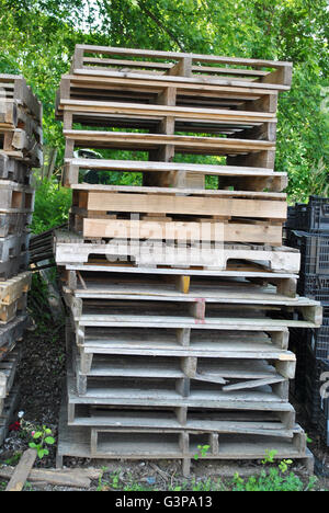 Stacked Wooden Pallets Discarded or Ready to be Used to Ship Products Stock Photo