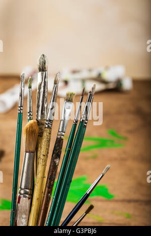 Artists brushes on a studio bench. Stock Photo