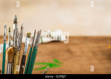 Artists brushes on a studio bench. Stock Photo