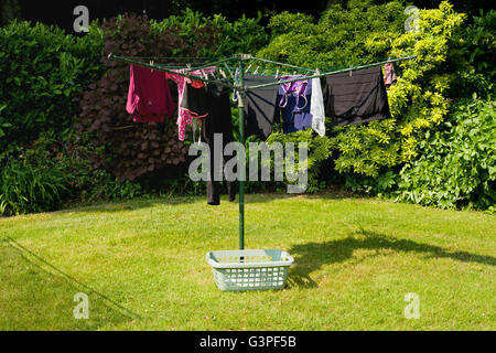 Washing line outdoors in a garden. Clothes hanging out to dry. Stock Photo