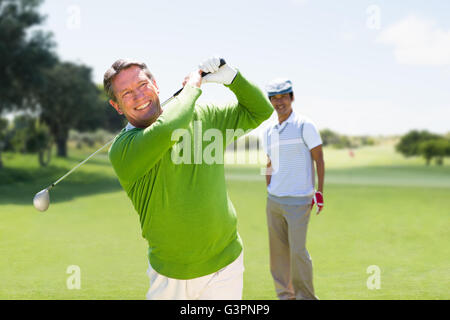 Composite image of man playing golf Stock Photo