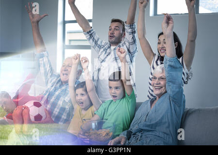 Composite image of family is watching sport on television Stock Photo