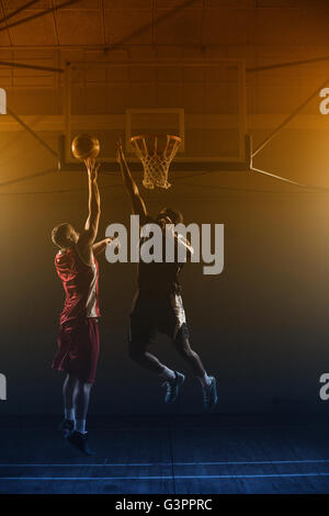 Basketballs player trying to scoring a basket Stock Photo