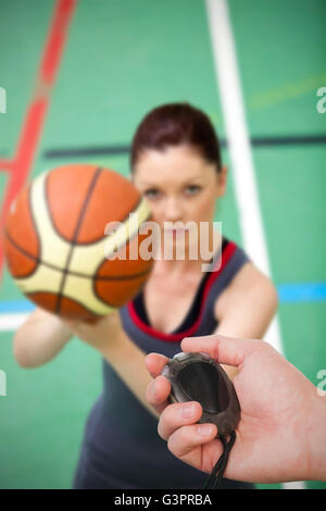 Composite image of close up of coach is holding a stopwatch Stock Photo