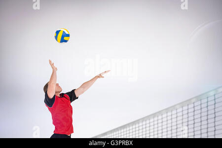 Composite image of sportsman hitting volleyball Stock Photo