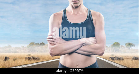 Composite image of athlete posing with arms crossed Stock Photo