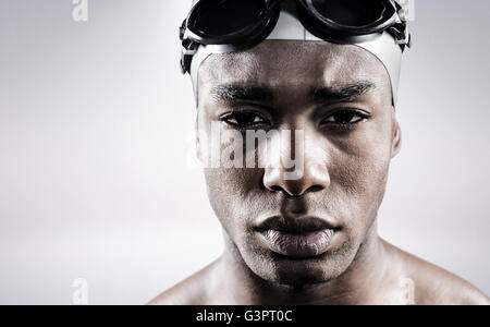 Composite image of portrait of swimmer in swimmingB goggles and swimming cap Stock Photo