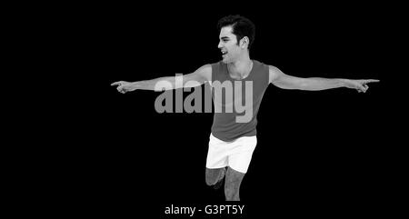 Excited male athlete with arms outstretched Stock Photo