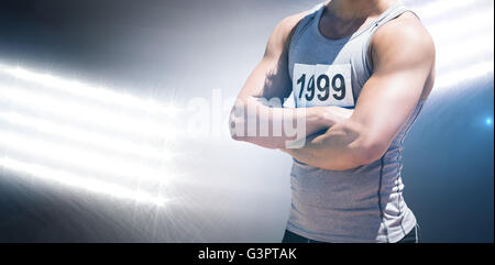 Composite image of handsome sportsman is posing with crossed arms Stock Photo