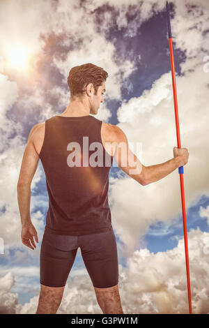 Composite image of rear view of male athlete holding javelin Stock Photo