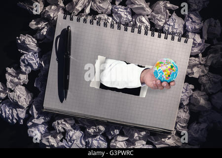 Composite image of businessman holding globe Stock Photo
