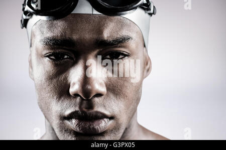 Composite image of portrait of swimmer in swimmingB goggles and swimming cap Stock Photo